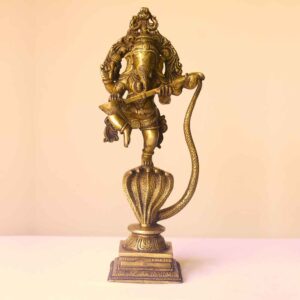 Brass statue of dancing ganesh on serpent